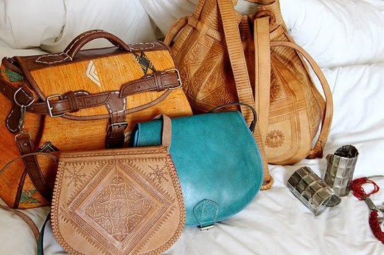 Handcrafted Moroccan leather bags made by artisans, featuring traditional embossing and natural materials